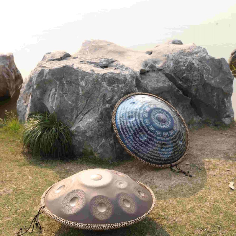 Handpan drum showcased by the edge of a picturesque lake during the day