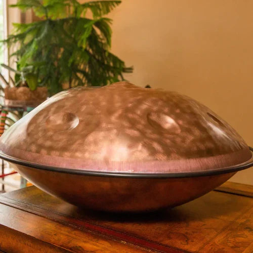 Golden handpan placed on bedside table in cozy room