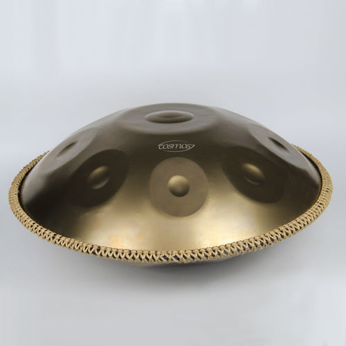 A stunning close-up of the Cosmos Handpan in gold, revealing its precise details