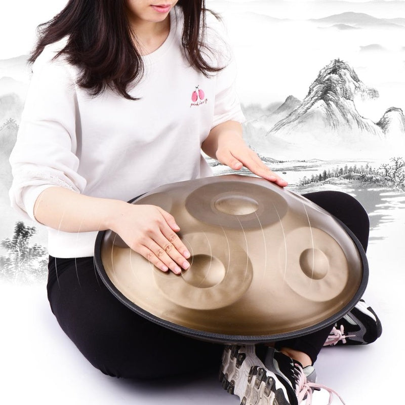 Female musician playing handpan in a cross-legged position, creating calming melodies in a serene and mindful setting. Perfect for relaxation and meditation.
