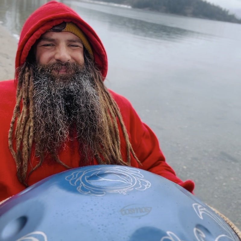 Cosmoshandpan ambassador demonstrating the beauty of a Cosmos handpan by the water.