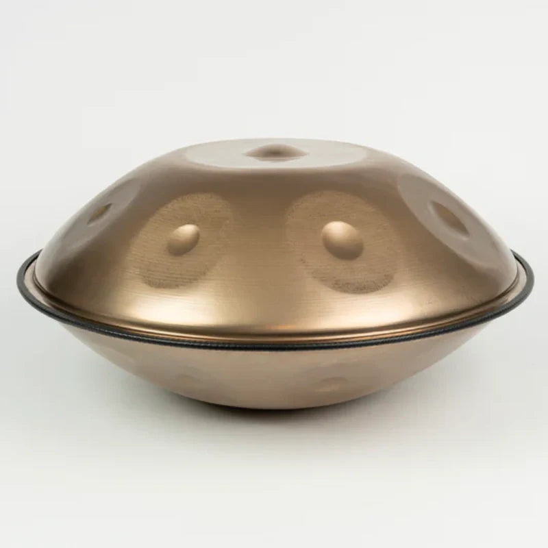 Close-up of a golden double-sided handpan highlighting its detailed craftsmanship and metallic finish.