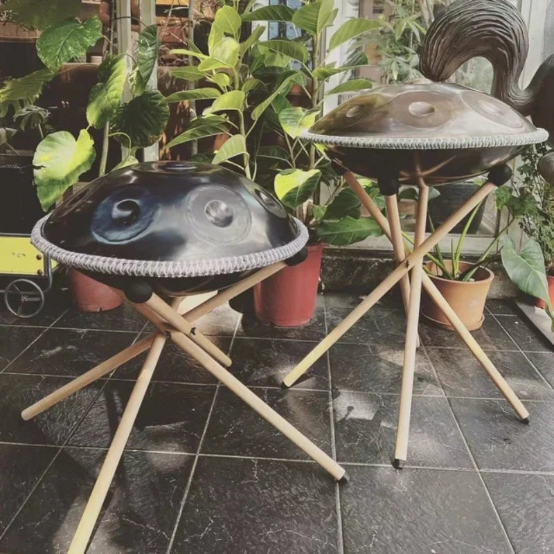 Two beautifully crafted handpans displayed in a plant-filled living room for relaxing home decor