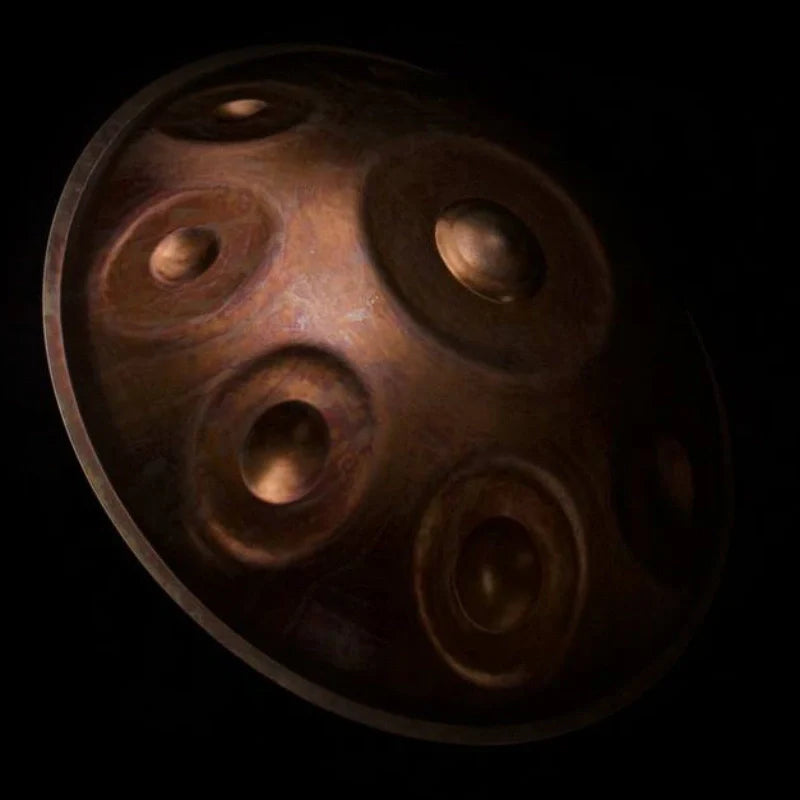 Close-up of a brown handpan drum showing detailed texture and craftsmanship.