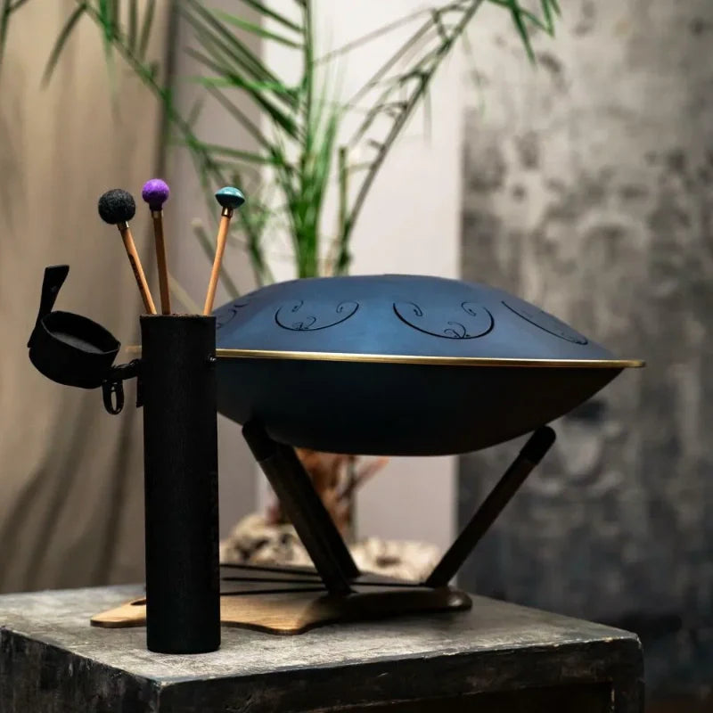 A beautiful handpan drum placed on a wooden table showcasing its design and craftsmanship.