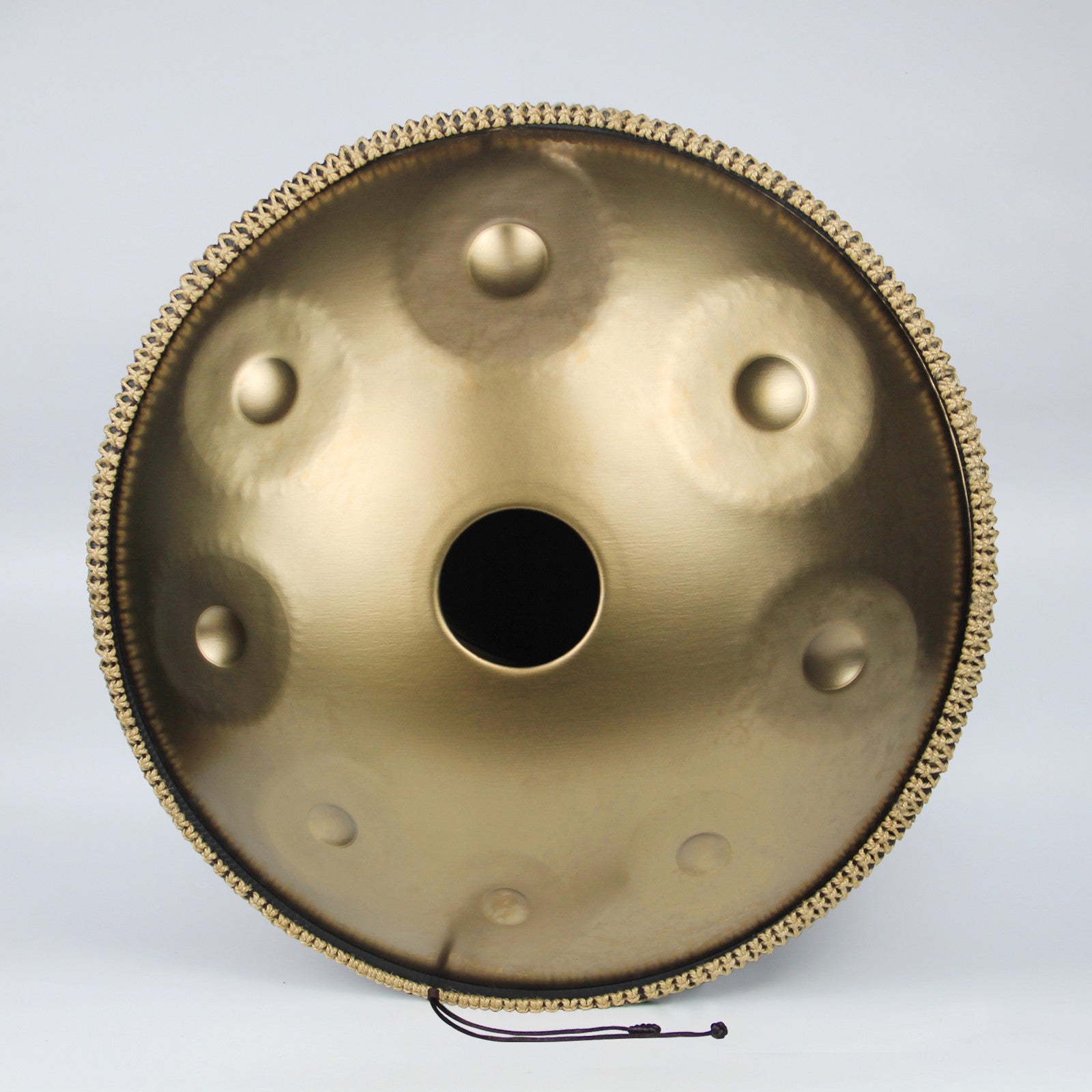 Handpan with a Golden metallic sheen and detailed craftsmanship