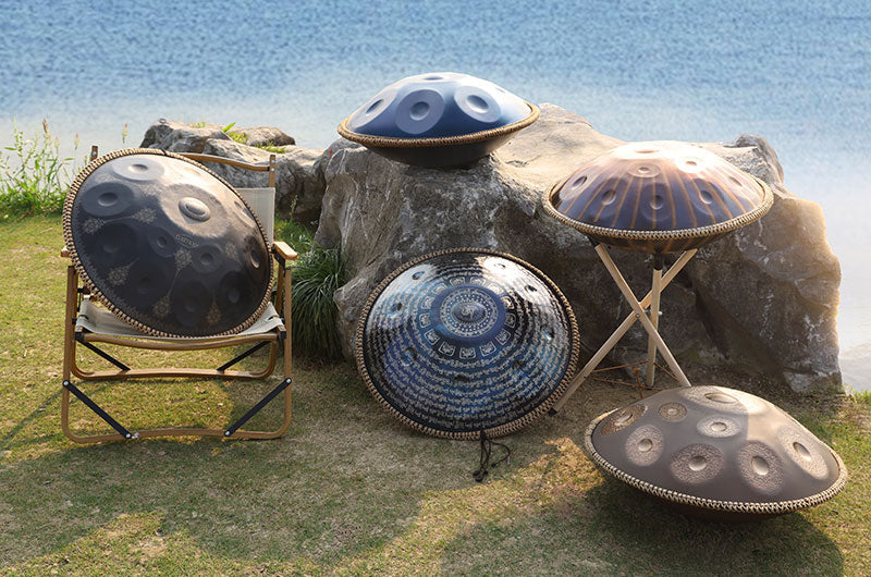 Diverse styles of handpan arranged by the lake