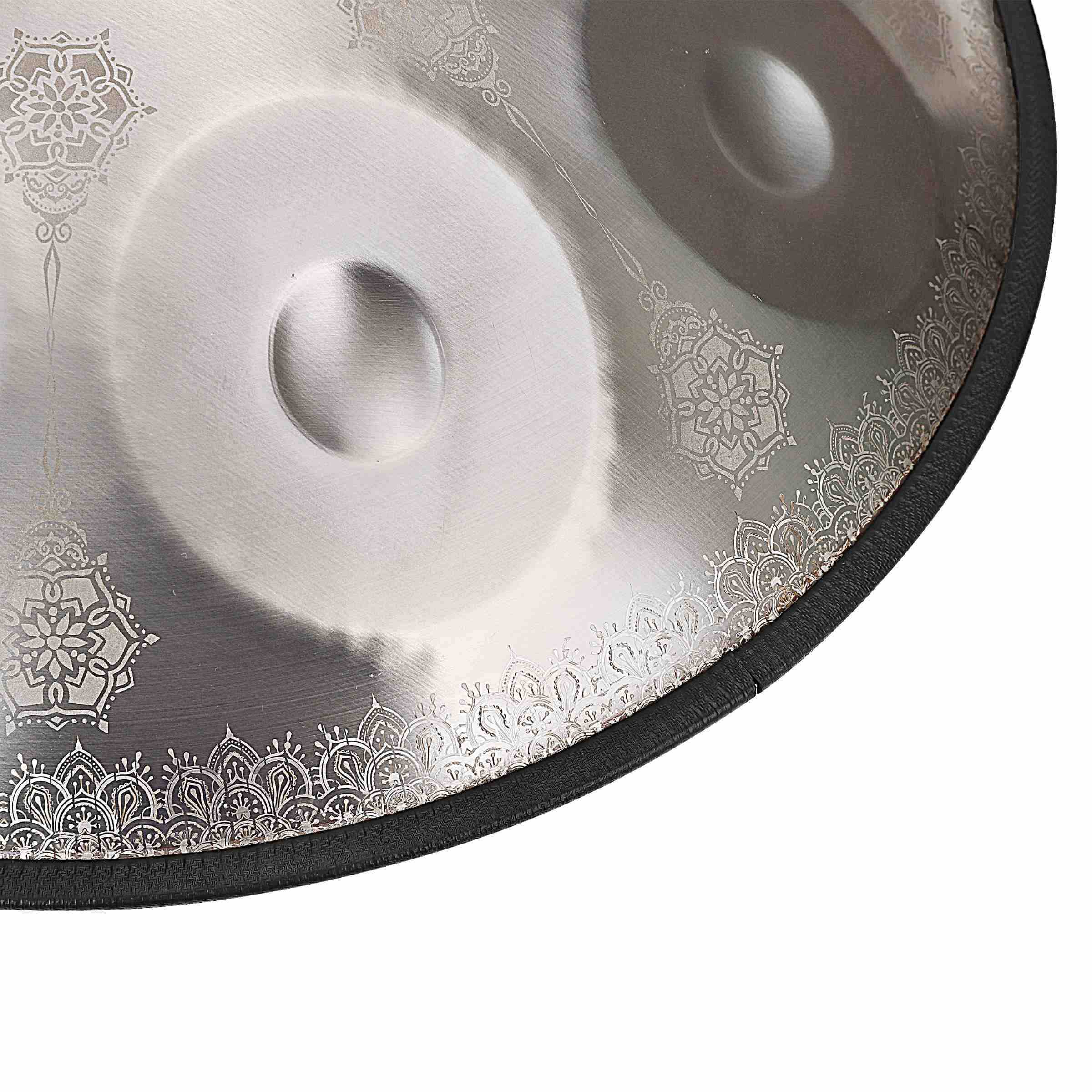Close-up of a shimmering Silver handpan drum with floral motifs