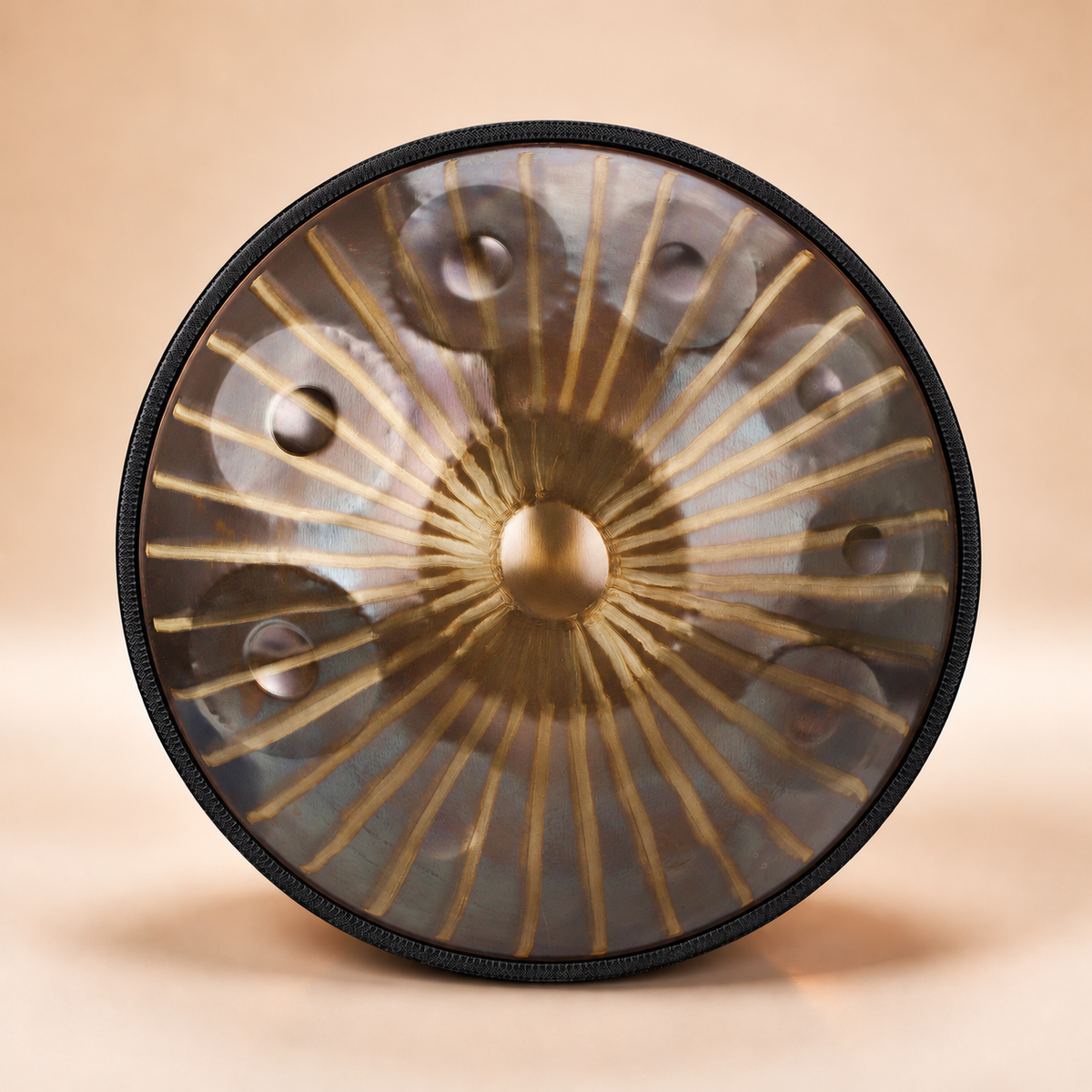 Gold handpan featuring intricate sun totem patterns