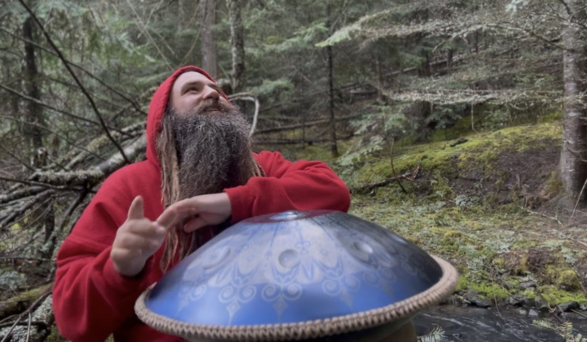 Musicians creating music with handpans by the lake.