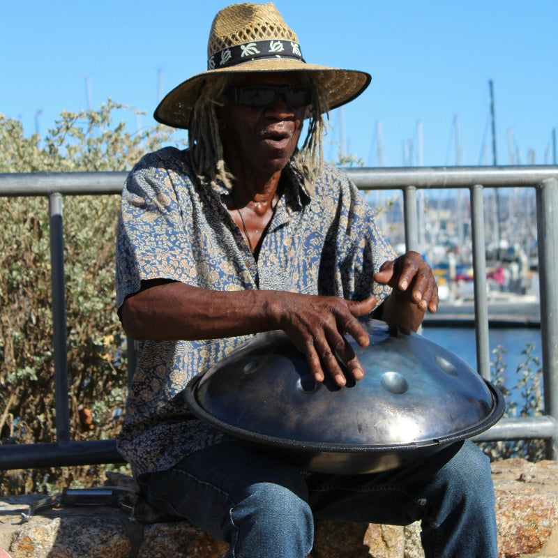 Musician playing a handpan outdoors