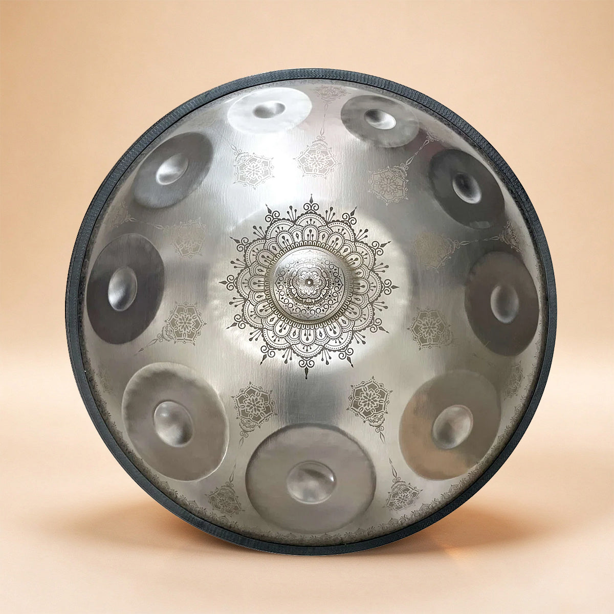 Silver handpan with delicate floral pattern