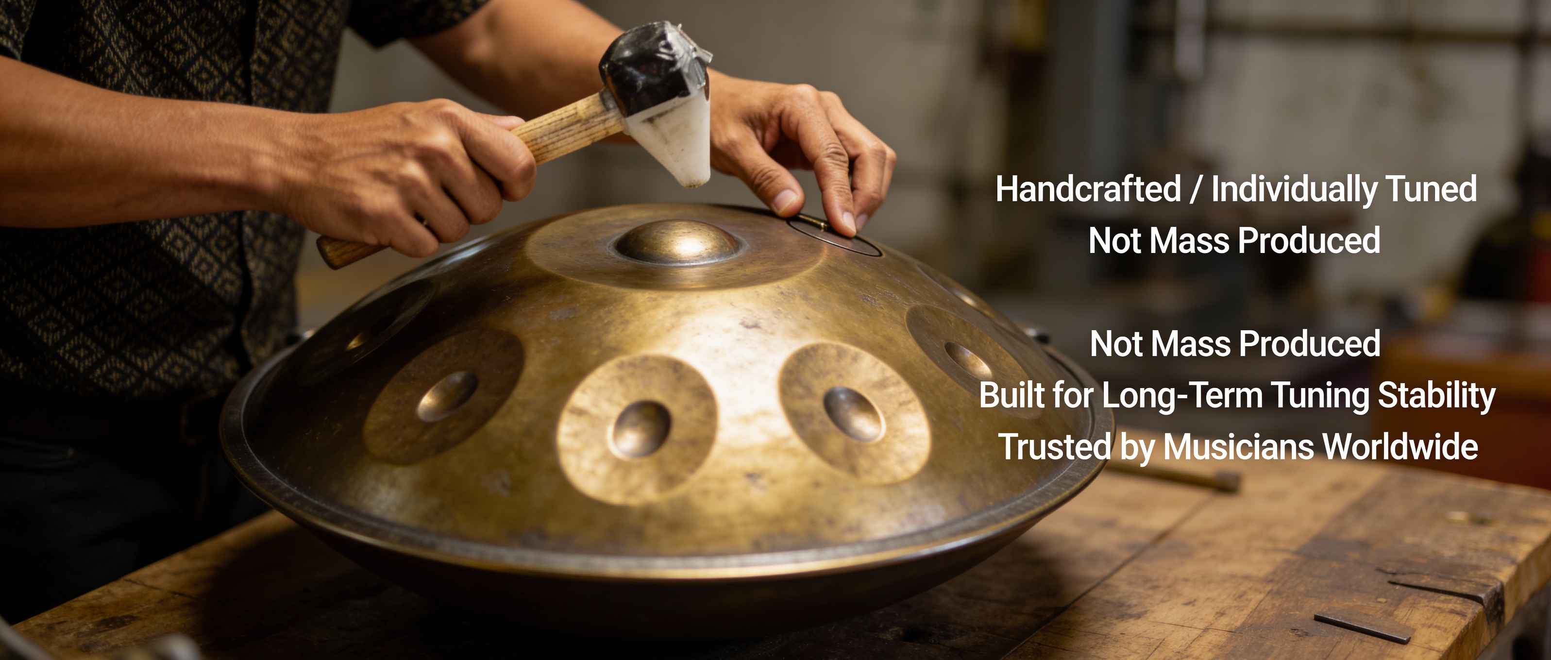 Person holding a handcrafted hang drum with text about its uniqueness and trustworthiness among musicians.